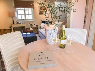 a table with two wine glasses and a sign on it at The Forge in Stowmarket