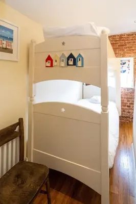 a bunk bed with houses on it in a room at Pebble Cottage - 6 Victoria Rd - Aldeburgh Coastal Cottages in Aldeburgh