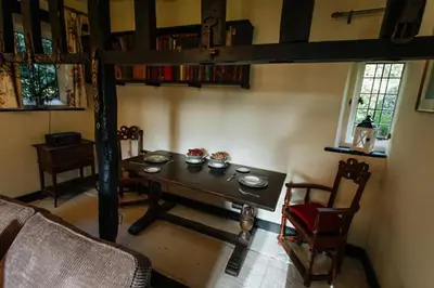 a dining room with a table and a loft bed at Elizabethan Manor House - Sleeps 2-4 - Parking in Burnham on Crouch