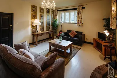 a living room with couches and a coffee table at Elizabethan Manor House - Sleeps 2-4 - Parking in Burnham on Crouch