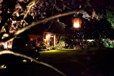 a house with christmas lights in a yard at night at Elizabethan Manor House - Sleeps 2-4 - Parking in Burnham on Crouch