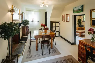 a living room with a wooden table and chairs at Elizabethan Manor House - Sleeps 2-4 - Parking in Burnham on Crouch