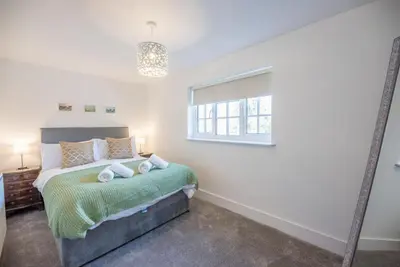 a bedroom with a bed and a window at Candy Cottage, Halesworth in Halesworth
