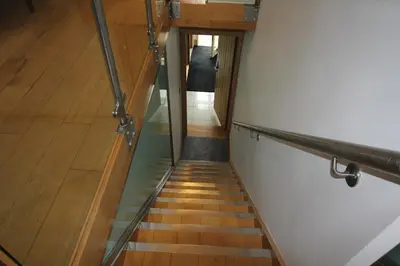 a hallway with a staircase leading up to a room at Cambridge city centre immaculate 2 bed apartment in Cambridge