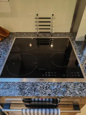 a stove top oven sitting inside of a kitchen at Cambridge city centre immaculate 2 bed apartment in Cambridge
