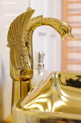 a bathroom sink with a gold faucet on it at Huge Deluxe 600 Year Old Essex Manor, Hot Tub, Cinema Room, Sky Tv in Saffron Walden