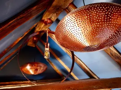 a metal fan hanging from a wooden ceiling at Huge Deluxe 600 Year Old Essex Manor, Hot Tub, Cinema Room, Sky Tv in Saffron Walden
