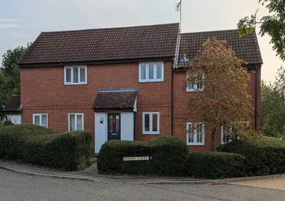 a red brick house with a white door at Froden Court in Billericay