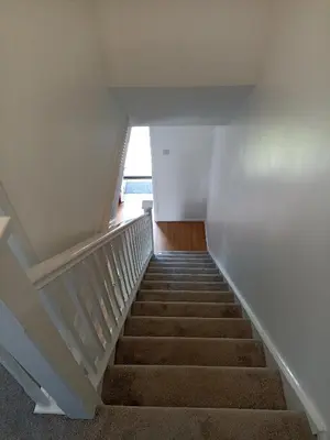 a staircase in a house with a stair case at Froden Court in Billericay