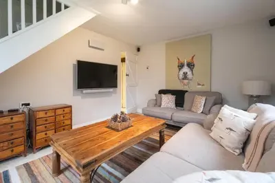 a living room with a couch and a coffee table at White Cottage, Iken - Aldeburgh Coastal Cottages in Snape