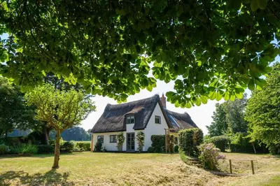 a white house with a thatched roof at White Cottage, Iken - Aldeburgh Coastal Cottages in Snape