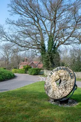 a bench sitting in the grass next to a tree at 3 Bed in Letheringham oc-pclet in Kettleburgh