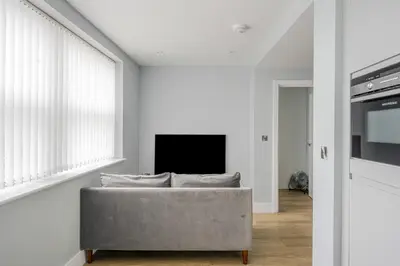 a living room with a couch and a tv at Luxury Apartment in Chelmsford Bond Street with Sky TV, Movies & Netflix in Chelmsford