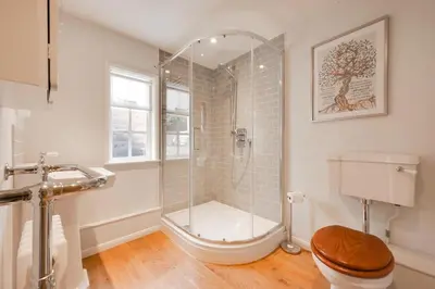 a bathroom with a shower and a toilet at 4 Bed in Westleton oc-holc in Westleton