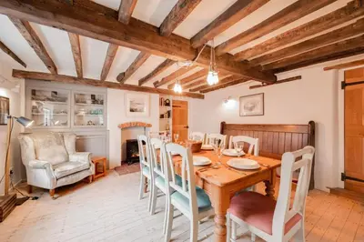 a dining room with a wooden table and chairs at 4 Bed in Westleton oc-holc in Westleton