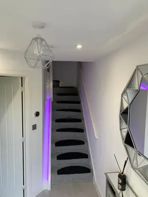a spiral staircase in a house with purple lighting at A BYK luxury modern home that sleeps 2 - 8 people in Horndon on the Hill
