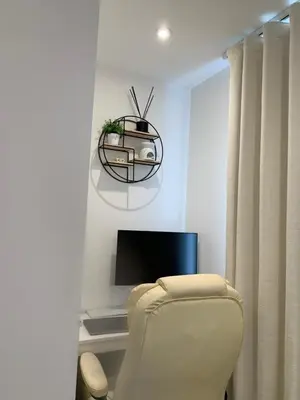 a living room with a chair and a tv at A BYK luxury modern home that sleeps 2 - 8 people in Horndon on the Hill