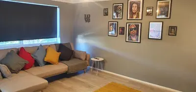 a living room with a couch and pictures on the wall at The Court in Braintree