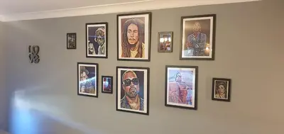 a bunch of framed pictures on a wall at The Court in Braintree