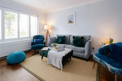 a living room with a couch and two chairs and a table at 2 Hillcrest - Aldeburgh Coastal Cottages in Leiston