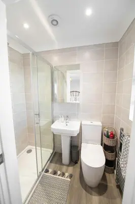 a bathroom with a toilet and a sink and a shower at La Casita - Inside the Gates of Frinton-On-Sea in Frinton-on-Sea