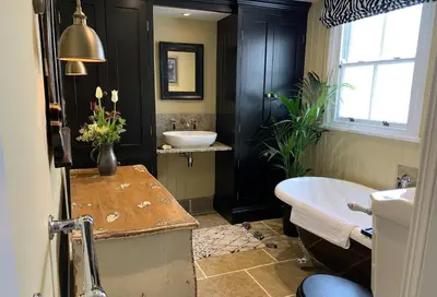 a bathroom with a sink and a bath tub and a sink at Cragside, Aldeburgh in Aldeburgh