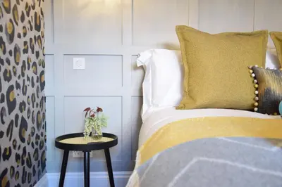 a bedroom with a bed and a side table at Cragside, Aldeburgh in Aldeburgh