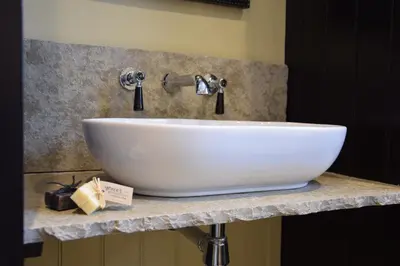 a white sink on a counter in a bathroom at Cragside, Aldeburgh in Aldeburgh