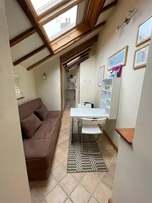 a living room with a couch and a table at Cobwebs in Kedington