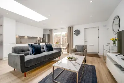 a living room with a couch and a table at Citystay Living - Finch House in Cambridge