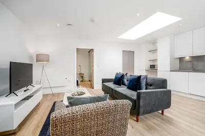 a living room with two couches and a tv at Citystay Living - Finch House in Cambridge