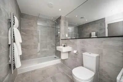 a bathroom with a toilet and a sink and a shower at Citystay Living - Finch House in Cambridge