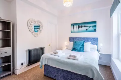 a bedroom with a bed with two towels on it at Cornerstone, Aldeburgh in Aldeburgh