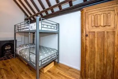 a bunk bed in a room with a door at Beautiful grade II listed 4 bed Victorian Conversion - Billericay Essex in Billericay