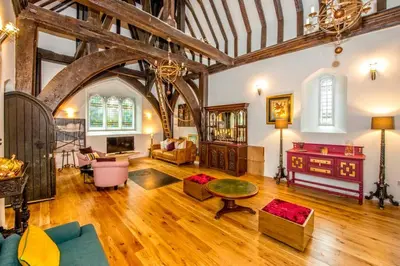 a large living room with wooden floors and a large ceiling at Beautiful grade II listed 4 bed Victorian Conversion - Billericay Essex in Billericay