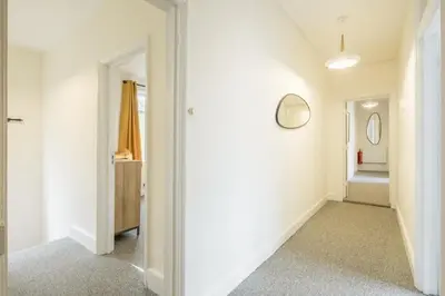 a hallway with white walls and two mirrors on the wall at Fabulous Large Apartment for 7 - CENTRAL Cambridge in Cambridge