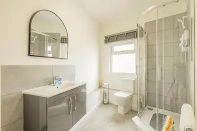 a bathroom with a sink and a toilet and a mirror at Fabulous Large Apartment for 7 - CENTRAL Cambridge in Cambridge