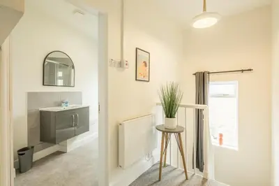 a bathroom with a sink and a mirror and a stool at Fabulous Large Apartment for 7 - CENTRAL Cambridge in Cambridge