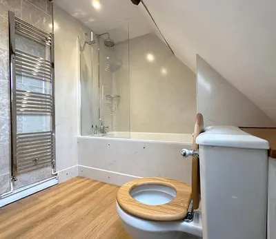 a bathroom with a toilet and a shower at The Coach House Barn - Valley Farm in Sudbourne