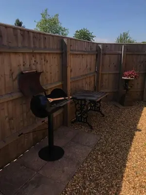 a patio with a bench and a fence at The Knox - Beautiful Two Bed Cottage Near Orford in Woodbridge