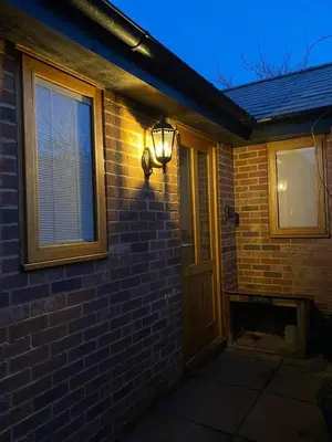 a light on the side of a brick house at The Knox - Beautiful Two Bed Cottage Near Orford in Woodbridge