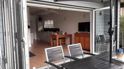 a screened in porch with a table and chairs at The Annexe, Cornfields in Elmswell