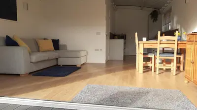 a living room with a couch and a table at The Annexe, Cornfields in Elmswell