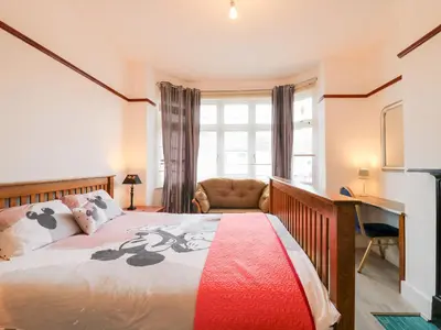 a bedroom with a bed and a desk at Ninety Eight in Southend-on-Sea