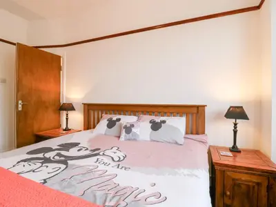 a bedroom with a bed with hello kitty pillows on it at Ninety Eight in Southend-on-Sea