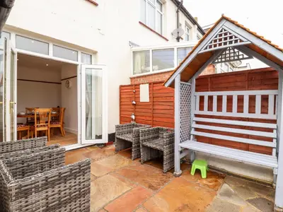 a patio with a bench and a table at Ninety Eight in Southend-on-Sea