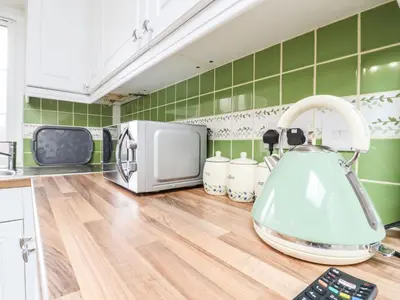 a kitchen with a microwave and a wooden counter top at 493 Little Wakering Road in Southend-on-Sea