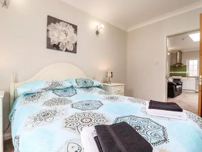 a bedroom with a blue and white bed with towels on it at 493 Little Wakering Road in Southend-on-Sea