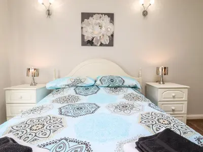 a bedroom with a bed with two night stands at 493 Little Wakering Road in Southend-on-Sea
