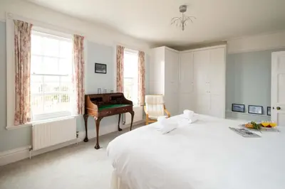 a bedroom with a bed and a desk in it at 4 Crespigny House - Aldeburgh Coastal Cottages in Aldeburgh